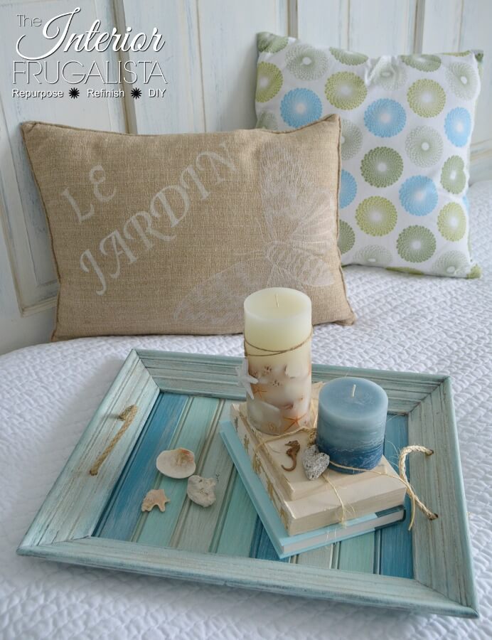 How to easily repurpose a picture frame into a handy serving tray for summer with wood slats painted pretty coastal colors and sisal rope handles.