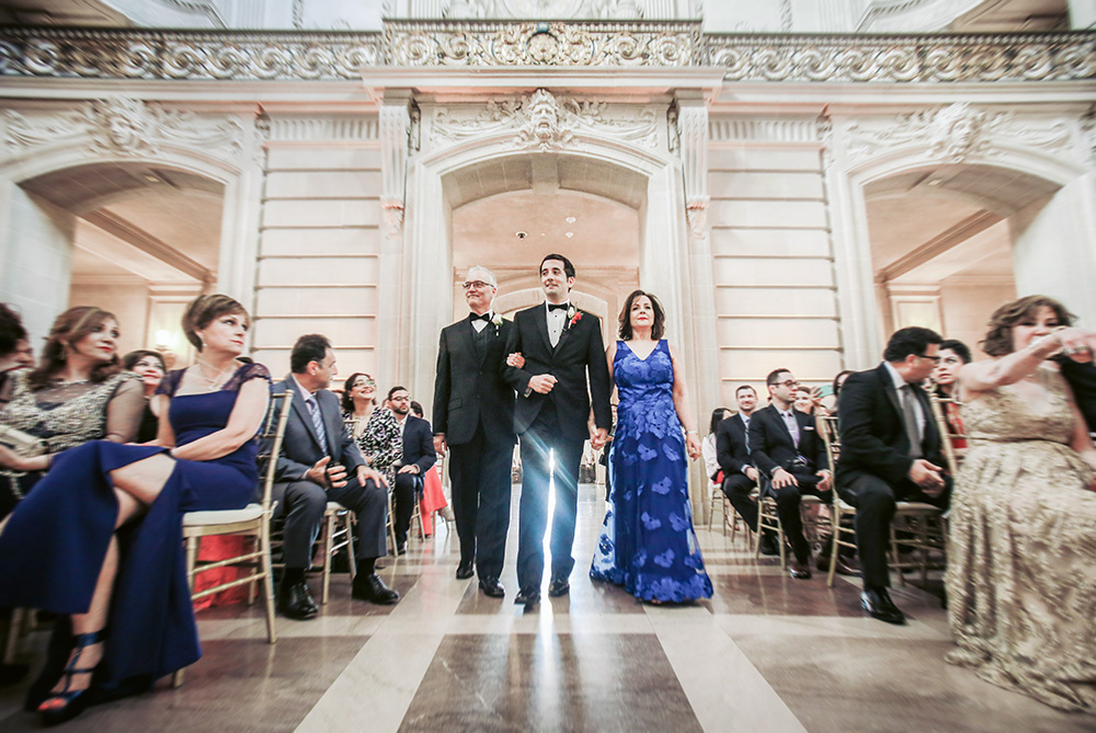 groom and parents walking down aisle