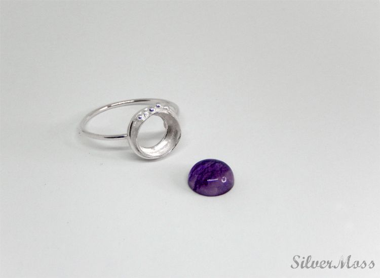 Fluorite Gemstone Cabochon and Sterling Silver Ring Setting - SilverMoss Jewellery purple fluorite gemstone cabochon next to a handcrafted sterling silver ring setting