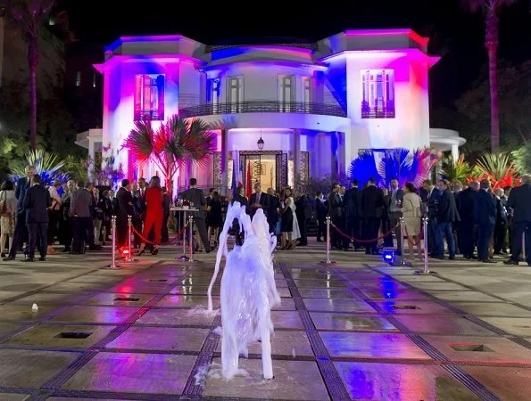 Prince Guillaume and Princess Stephanie attended a reception at Villa des Arts in Casablanca. v-neck midi dress orange
