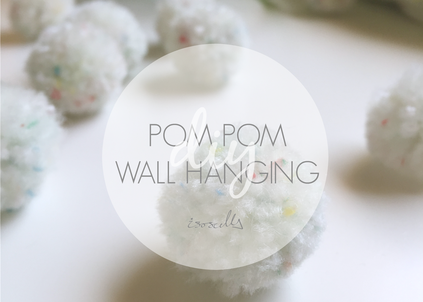 DIY pom pom wall hanging by isoscella