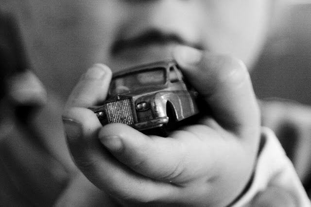 Baby holding toy car