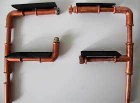 One-twelfth industrial-style pipe shelving unit.
