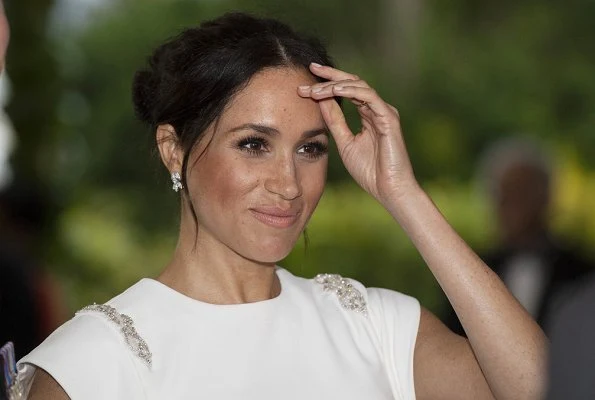 Meghan Markle wore THEIA ivory cap sleeve beaded shoulder gown, Birks snowflake snowstorm diamond earrings and carried Givenchy satin clutch