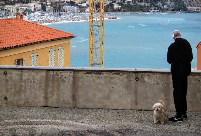 Things to see in Menton France - sea views, man with dog