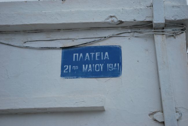Blue sign on white wall in greek Plateia 21st May 1940