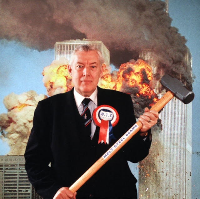 A defiant looking Ian Paisley stands in front of the burning World Trade Towers in New York. He holds a sledge hammer that reads 'Melt Steel Beams'