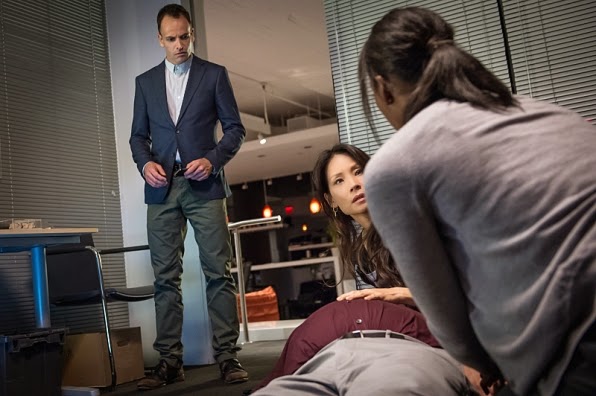 Jonny Lee Miller Lucy Liu as Sherlock Holmes Joan Watson investigating a corpse in CBS Elementary Season 3 Episode 4 Bella Sherlock Holmes Joan Watson investigating a corpse in CBS Elementary Season 3 Episode 4 Bella