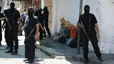 Hamas members prepare to execute Palestinians for allegedly spying for Israel in August 2014. Hamas members prepare to execute Palestinians for allegedly spying for Israel in August 2014.
