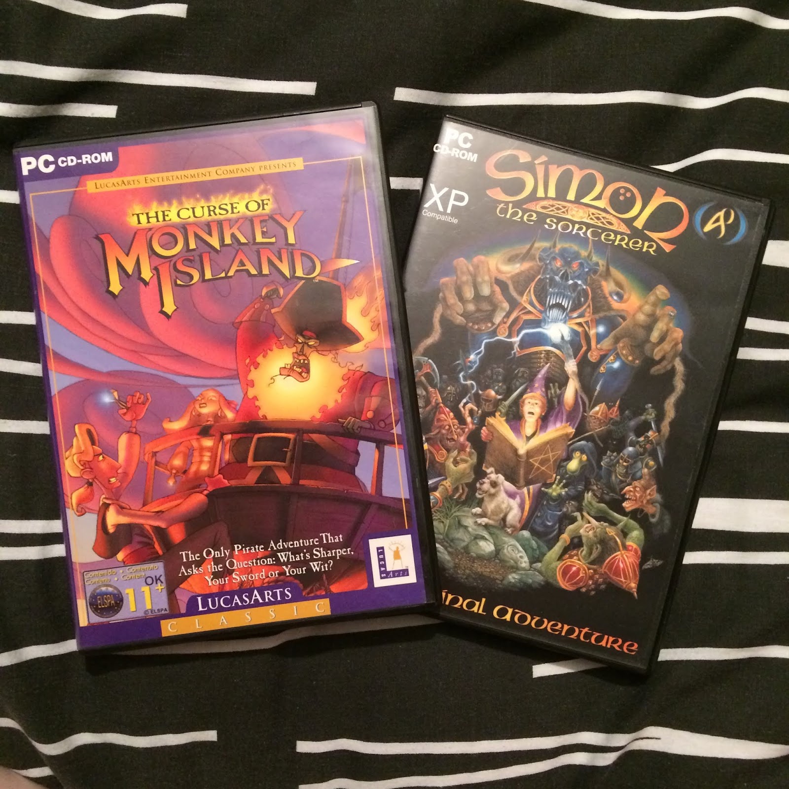 A photo of the cases for The Curse of Monkey Island and Simon the Sorcerer