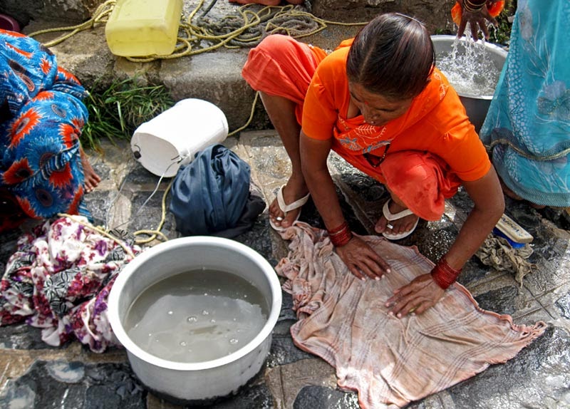woman washing clothes by hand