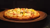 Pizza serving on a wooden spoon for pizza Recipe