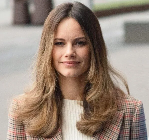 Princess Sofia wore a long checked duster coat by 2ndDay. camel bag and pants. Tommy Hilfiger claret red velvet jacket