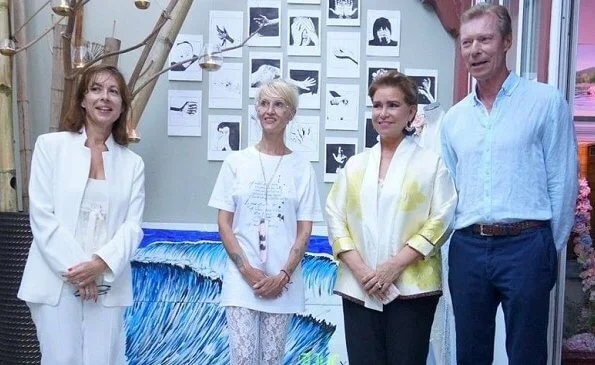 Grand Duchess Maria Teresa wore a silk kimono-style jacket by Anelore. The royal couple visited french designer Anelor's fashion show in Biarritz