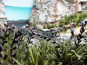 Miniature New Zealand flax plants in a diorama.