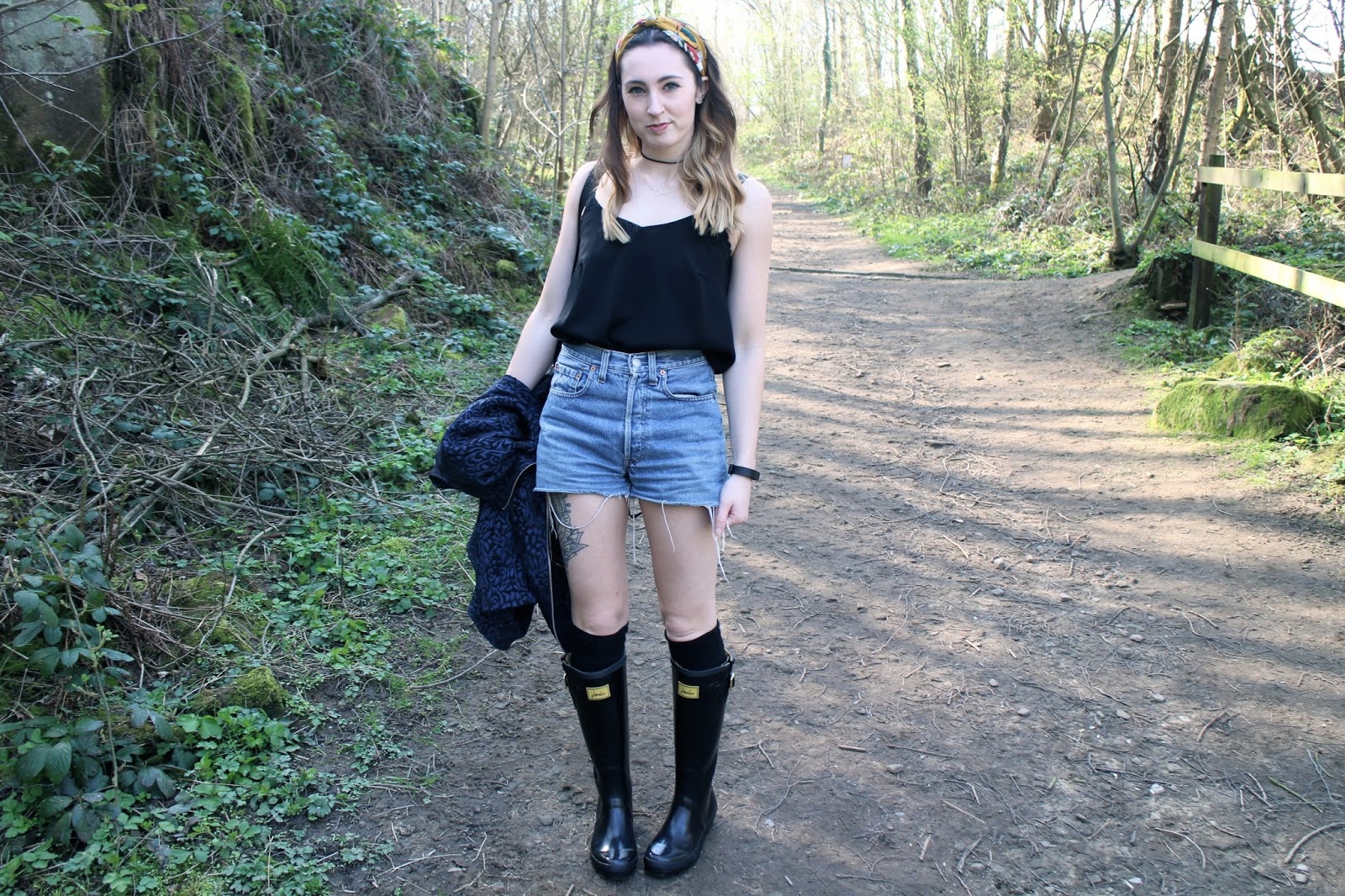 Festival fashion with vintage shorts, wellies and tattoos