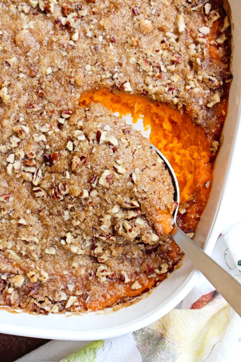Brown Sugar Pecan Sweet Potato Casserole is made with creamy mashed sweet potatoes and an irresistible brown sugar pecan topping.  It is a holiday-worthy side dish that you will want to make year after year! #sidedishrecipe #sweetpotatoes #casserole