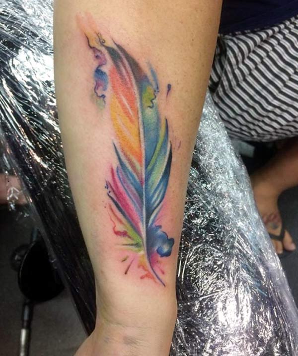 The design is really stunning and beautiful watercolor effect feather tattoo art for the girl's forearm
