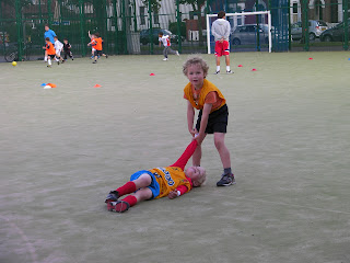 lazy footballer getting dragged along by his friend