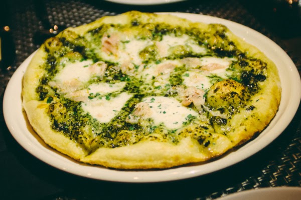 Porchetta, kale pesto and mozzarella pizza at Italian restaurant Moto cucina and enoteca in Nashville, Tennessee