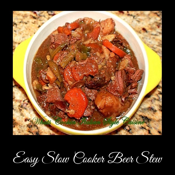 This is a yellow ceramic dish filled with beer stew that has been slow cooked in a slow cooker all day in a sauce with peas, carrots, potatoes, pot roast that is juicy and fork tender beef roast