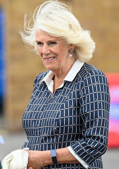 The Duchess visited South Western Ambulance Service. pearl earrings blue print collar midi dress, pearl necklace, beige pumps