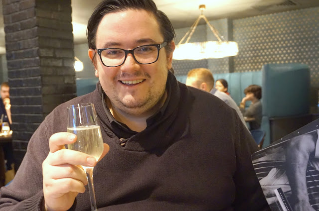 man holding glass of prosecco