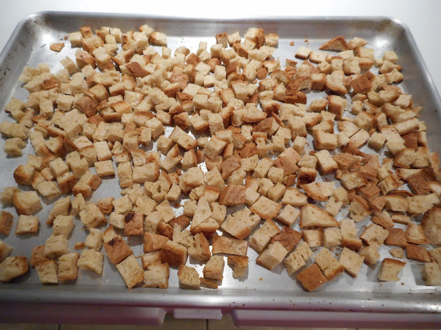 Gluten-free bread cut up into cubes for drying in the oven.