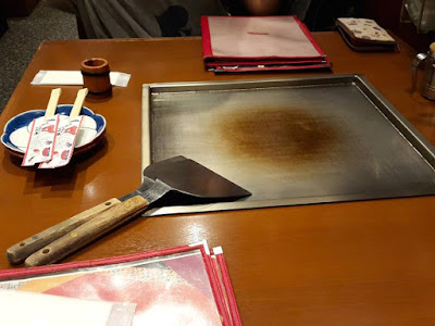 Frying okonomiyaki at Shinjuku Tokyo 