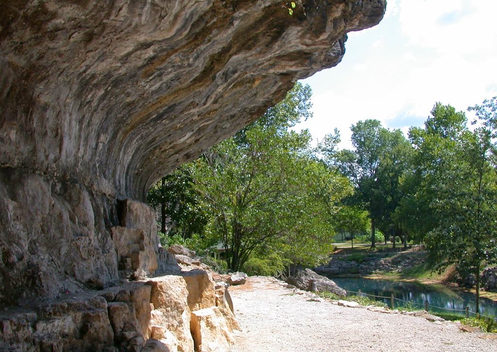 A towering rock overhang at Blue Spring Heritage Center in Eureka Springs