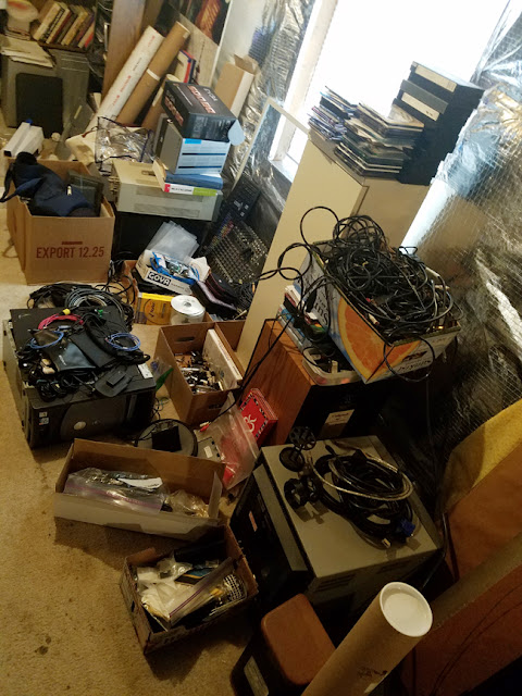 electronics, cables and stuff on floor of basement.