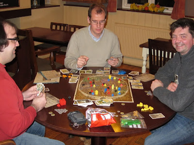 Discworld:Ankh-Morpork - The players with The Dragon King looking fairly happy about life in the troubled city