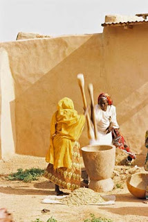 Pounding grain is a communal activity in Africa