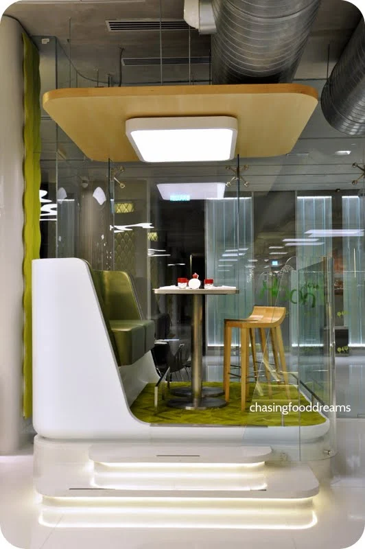 A futuristic restaurant scene with diners using augmented reality to view and customize their meals.