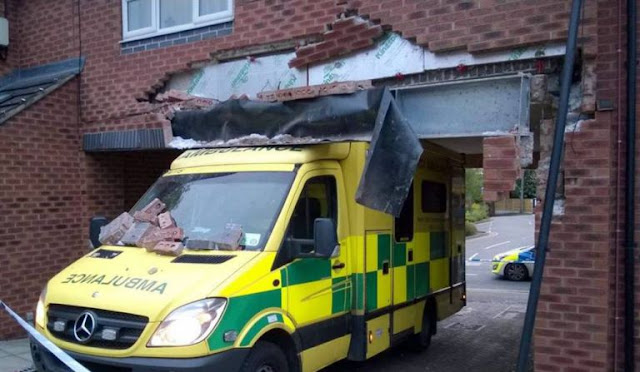 Woman Ambulance driver tries to fit under archway 