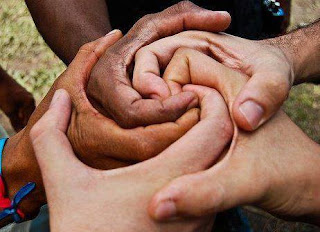 A clump of different size and skin tone hands