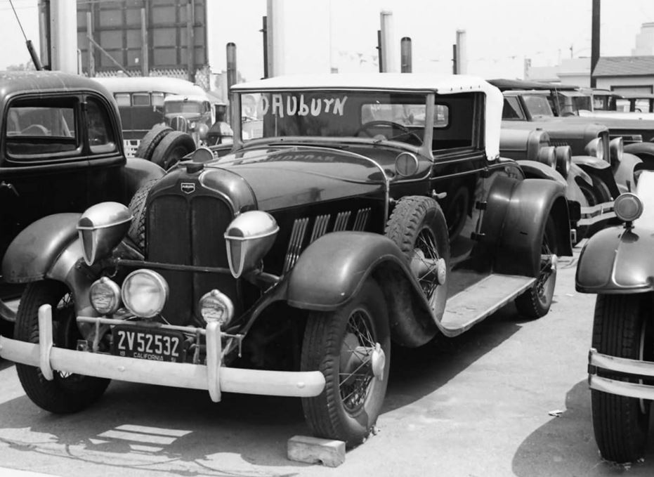 Just A Car Guy 30 Auburn with woodlites on a used car lot