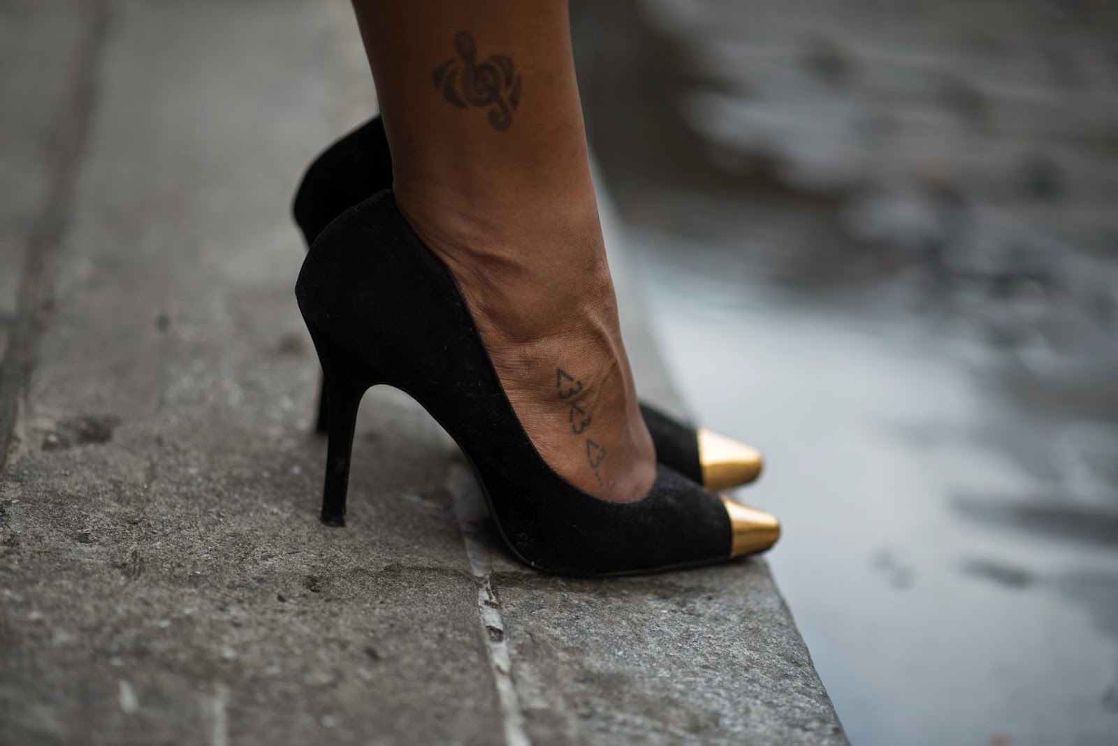 Black pumps, foot tattoo, ankle tattoo