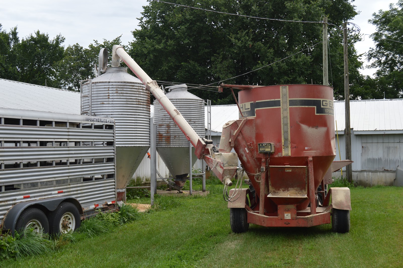 Industrial History Tractor implement to grind, mix, and deliver feed