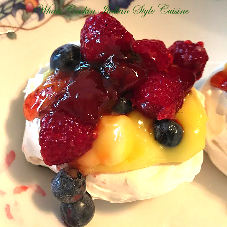 Meringue Cups that are filled with raspberry, blueberries, fresh pureed fruit and lemon curd. These meringue cups are an elegant dessert cup filled with delicious fresh fruits and an elegant dessert love in calories to serve guests.