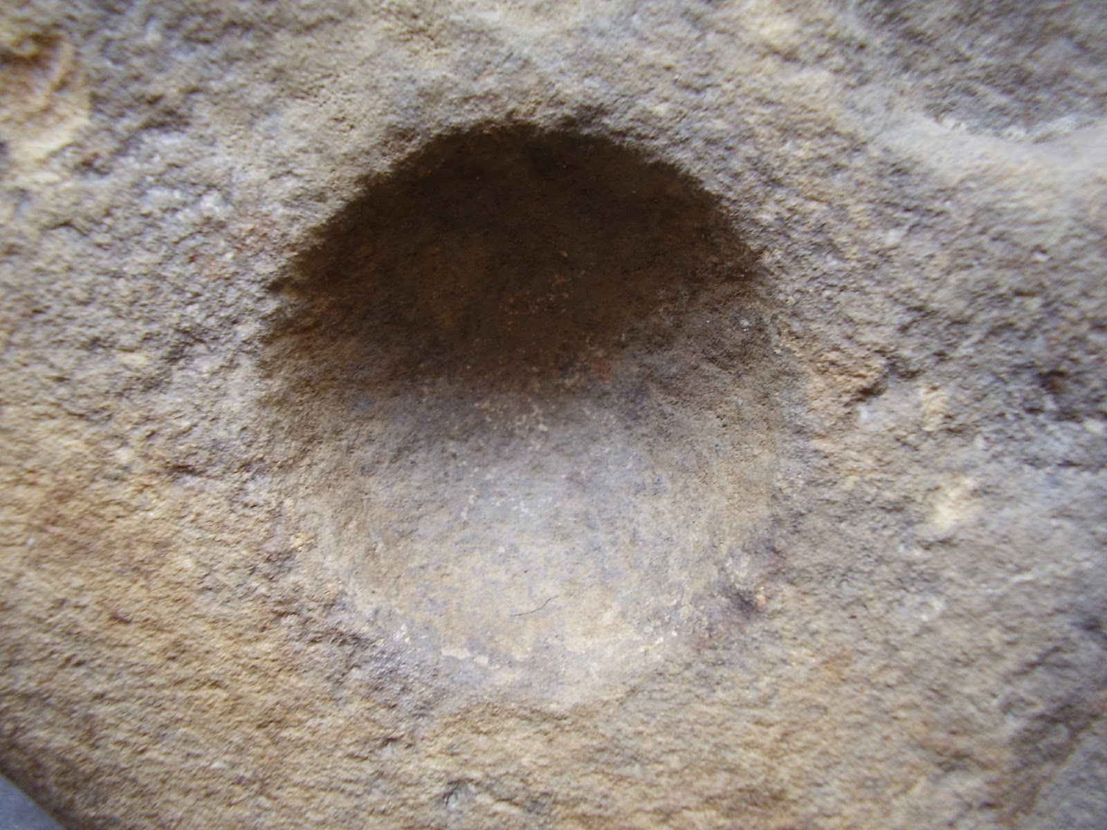 Archaeology of Portable Rock Art Rocks' pits may be art "cupules" on