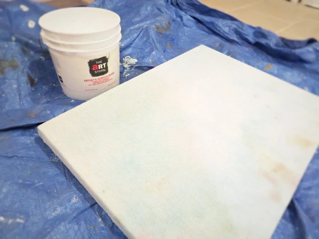 priming the canvas fabric on the frame