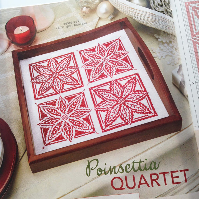 tray with four red cross-stitched poinsettias