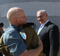 Noam Shalit embraces his son after more than five years of laboring for his freedom.