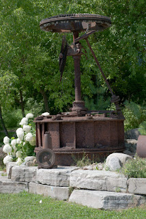 Millwheel Art Old wheels and parts from a mill make unique garden art.