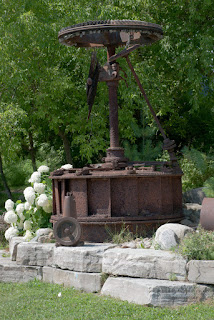 Old wheels and parts from a mill make unique garden art.