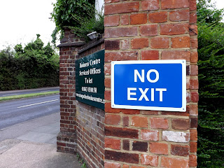 Photograph of 'No Exit' Information sign and green metal sign