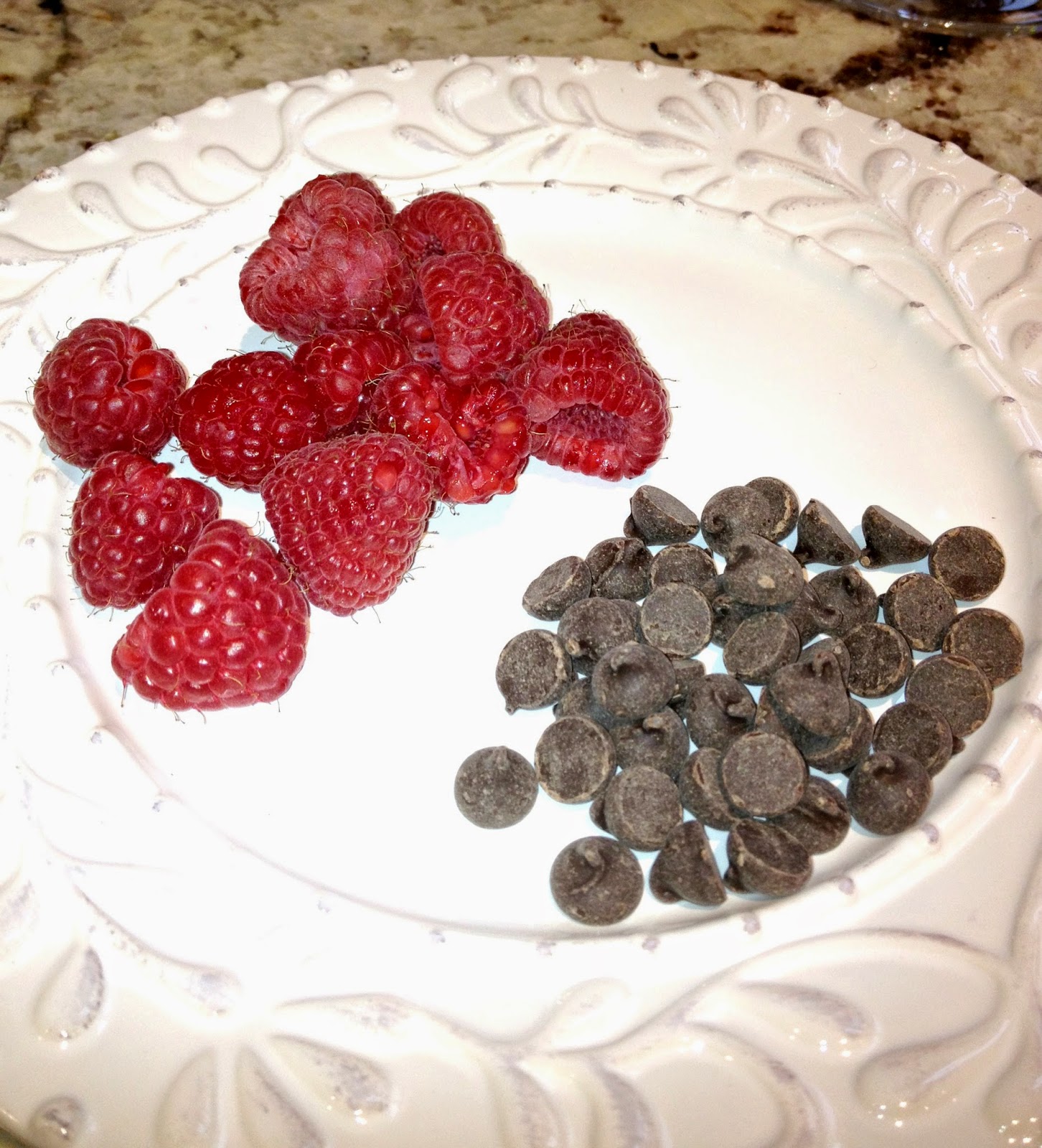 plate of red raspberries and dairy free chocolate chips
