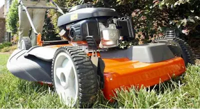 Husqvarna lawnmower cutting grass.