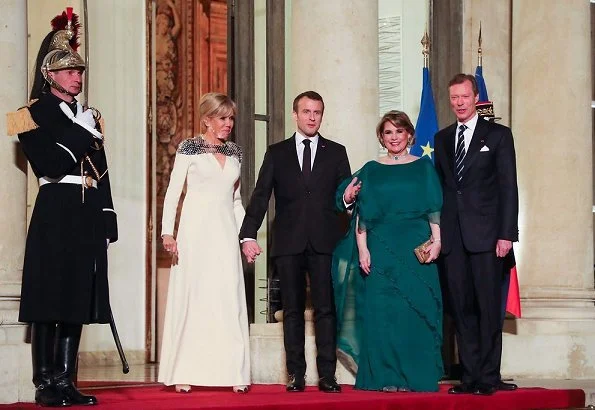 Brigitte Macron wore Louis Vuitton pumps, Duchess Maria Terasa wore Fendi fur coat and Miu Miu shoes for state dinner at Elysee Palace in Paris